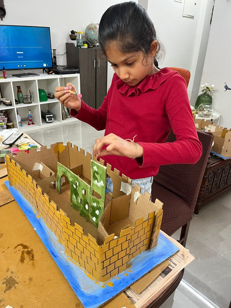 Kids at an Owtofbox in-person workshop building with real materials